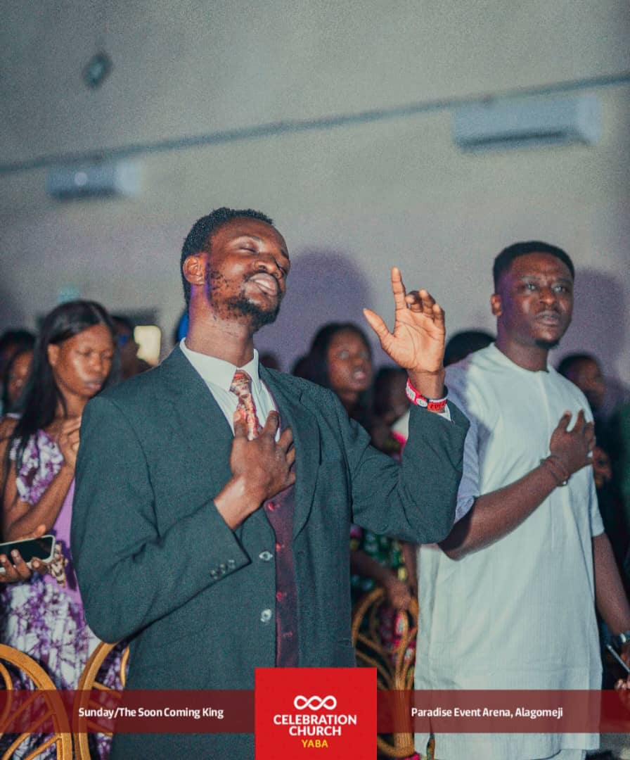 Congregants worshipping with lifted hands